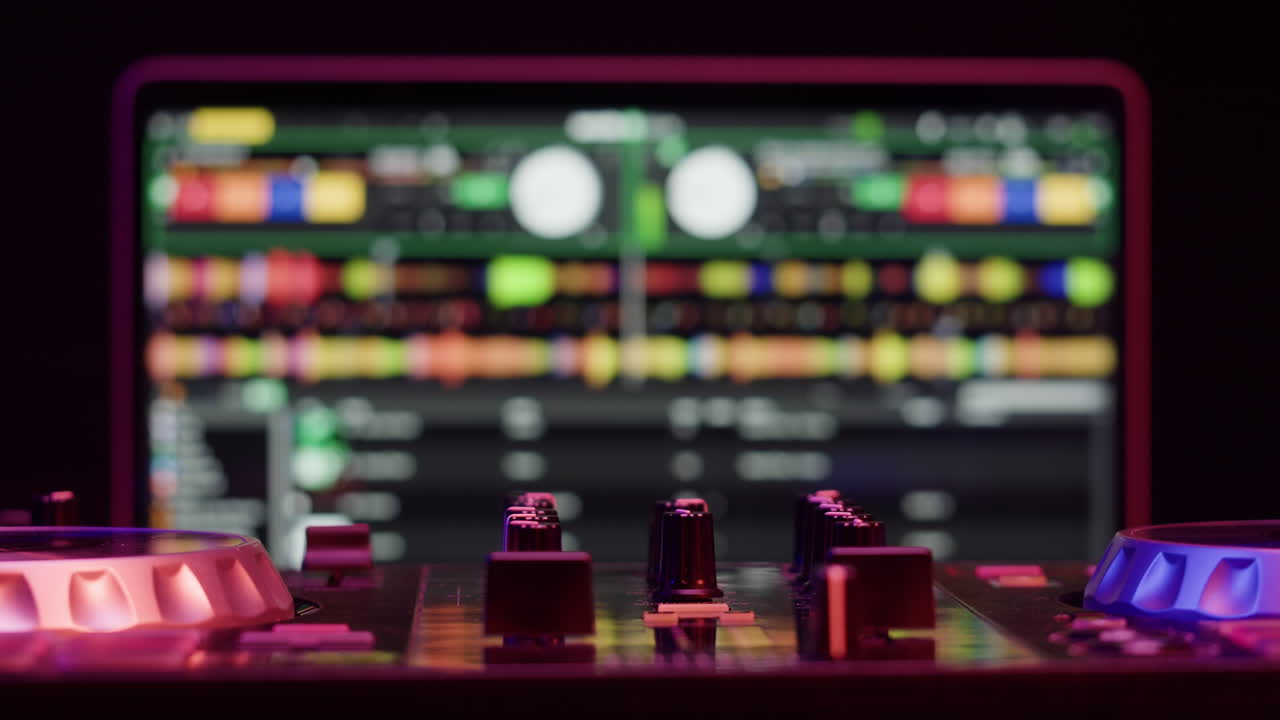 Closeup of DJ mixing console with vibrant lighting, used for music production and live performances at nightclubs
