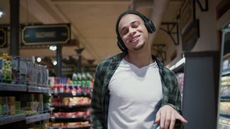 Mixed-race-guy-with-headphones-listening-to-the-music-and-funny-dance