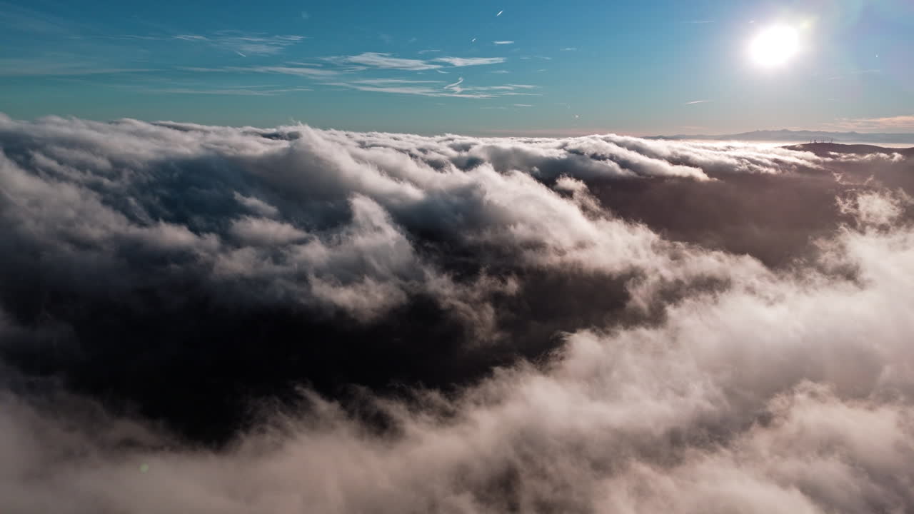 Soaring clouds beneath a bright sky at sunset, creating a peaceful scene