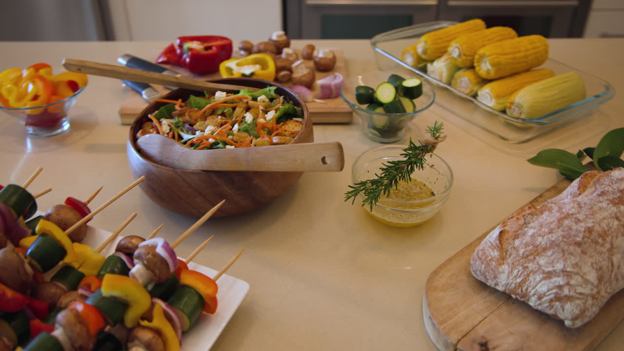Colorful vegetable skewers and fresh salad arranged on kitchen counter for meal prep, at home