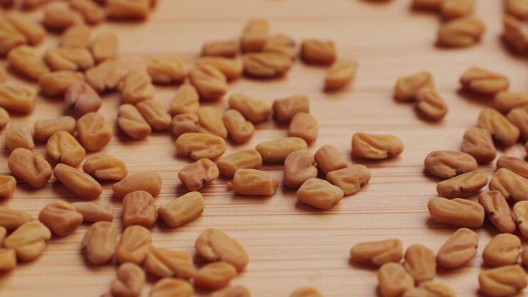 Close-up of Fenugreek Seeds Scattered on Wooden Surface