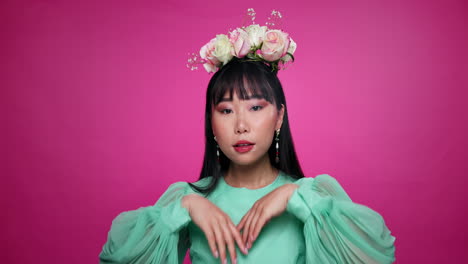 woman in floral crown and teal dress