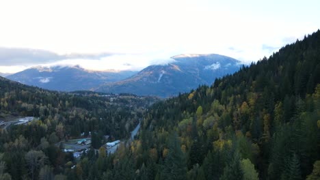 4k aerial footage of vast and colourful forest covered mountains in nelson, canada