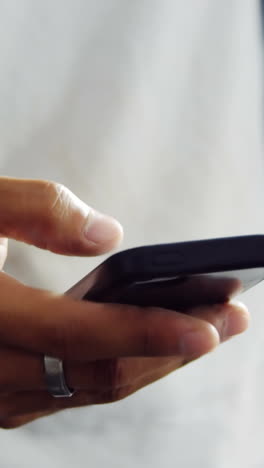 mechanic using mobile phone in workshop