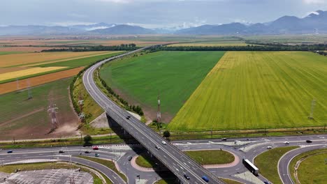 Pull-back-drone-video-of-highway-near-Brasov-with-mountains-background