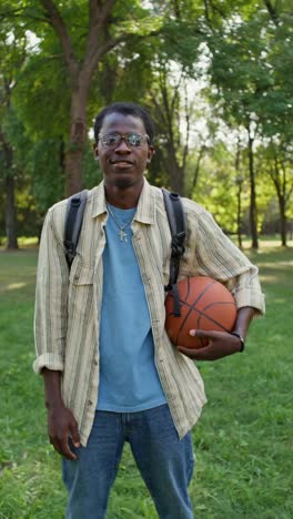 young man with basketball in a park