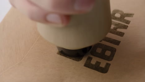 close-up of a rubber stamp creating an 'ebt hr' impression on paper