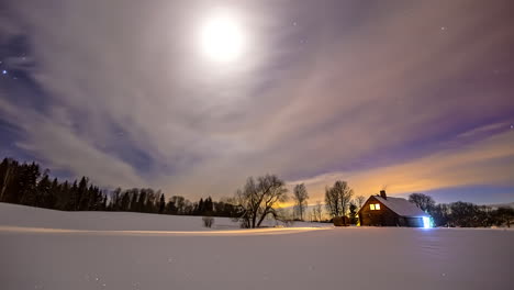 thermowood house at the snow-covered land at night