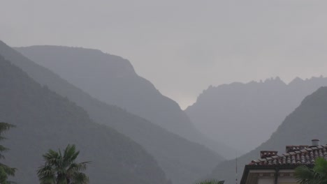 Beautiful-mountainscape-in-Riva-Del-Garda,-a-small-town-in-the-region-of-Trento-at-a-rainy-day-with-foggy-and-cloudy-sky