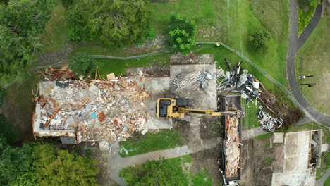 aerial view of building demolition by excavator