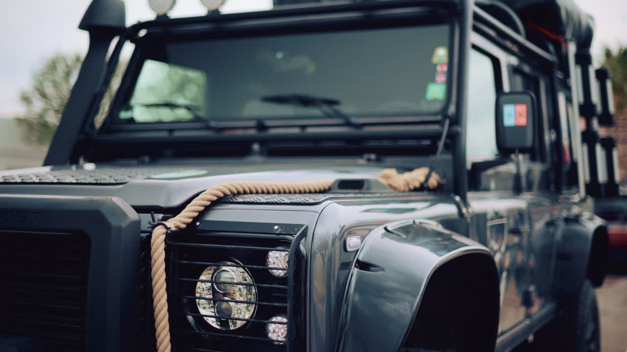 Close up of a rugged off road vehicle with a thick rope across its hood