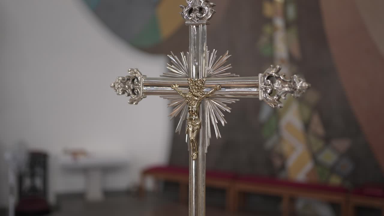Close up of ornate silver crucifix with gold details in church altar