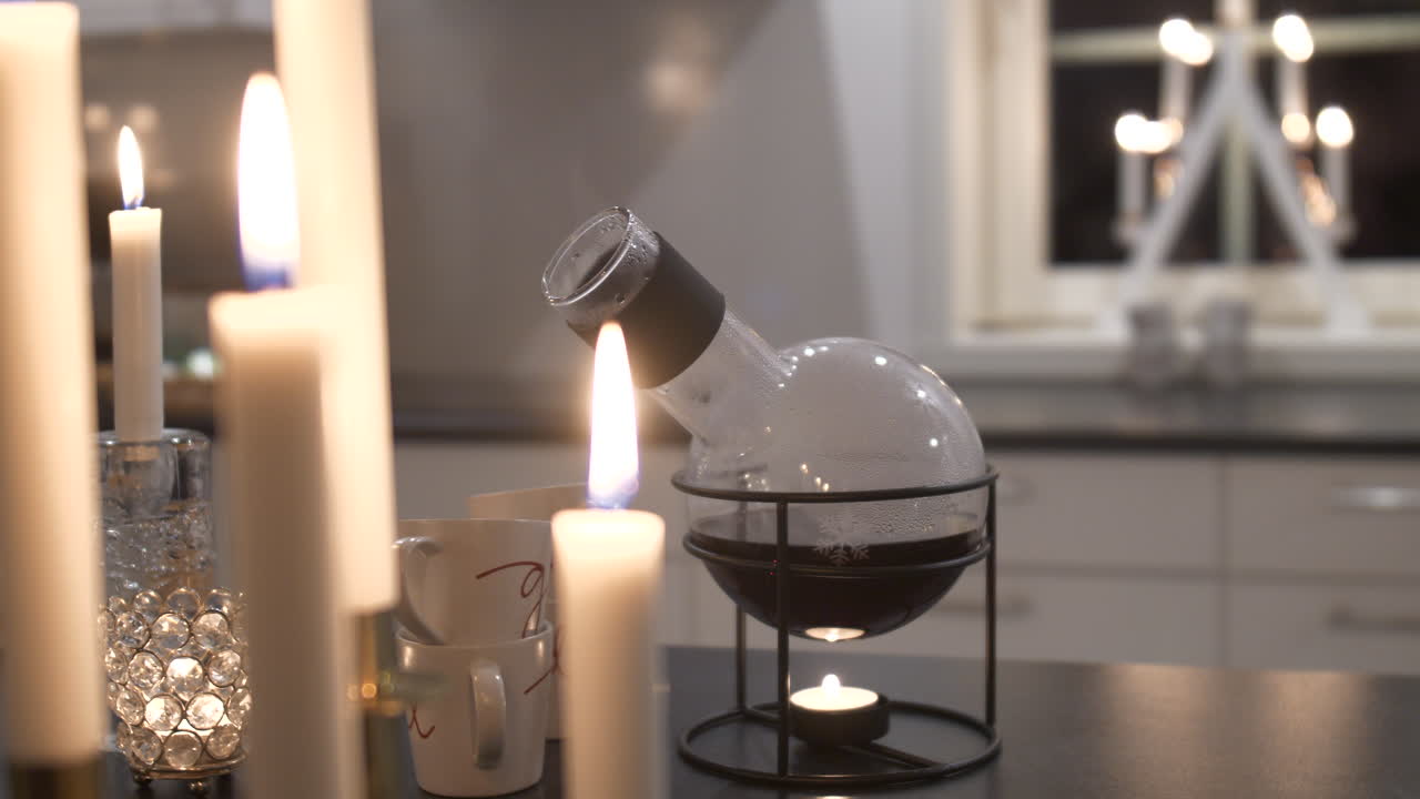 Candle light heating Mulled wine on kitchen island table