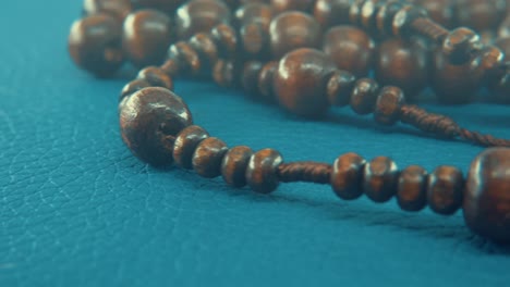 Macro-pan-shot-of-a-wooden-round-beads-necklace-with-coin-medallion