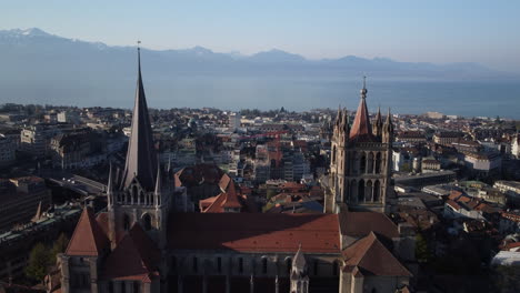 Slow-aerial-fly-over-between-two-large-towers-of-a-renaissance-building-in-Lausanne,-Switzerland