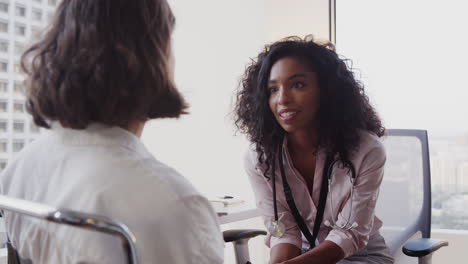 woman having consultation with female doctor in hospital office