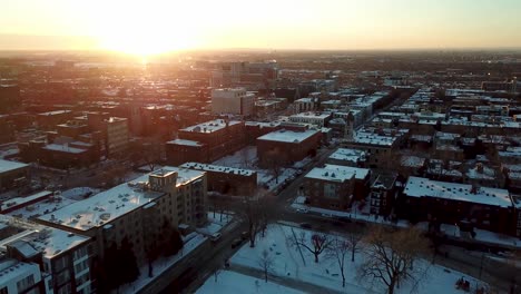 drone flying down over montreal in winter revealing an outdoor park rink with hockey players