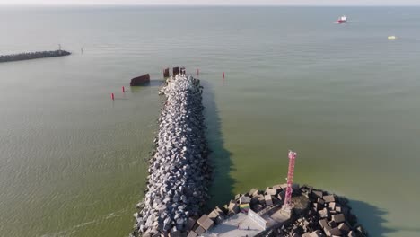 an aerial view of a breakwater at the harbor gate made of special stones