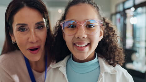 woman and girl smiling indoors