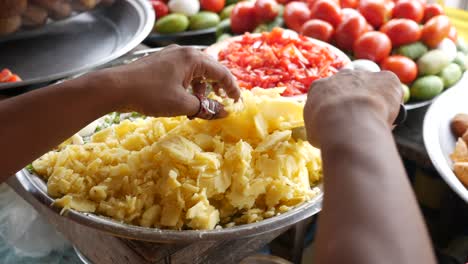 Rear-view-of-cutting-potato-in-street-,