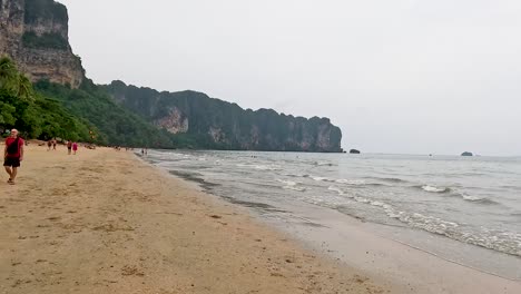 people strolling along a scenic beach