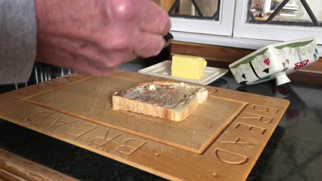 toast having butter and cherry jam spread on it in the kitchen of an oakham dwelling place in the county of rutland in england, united kingdom