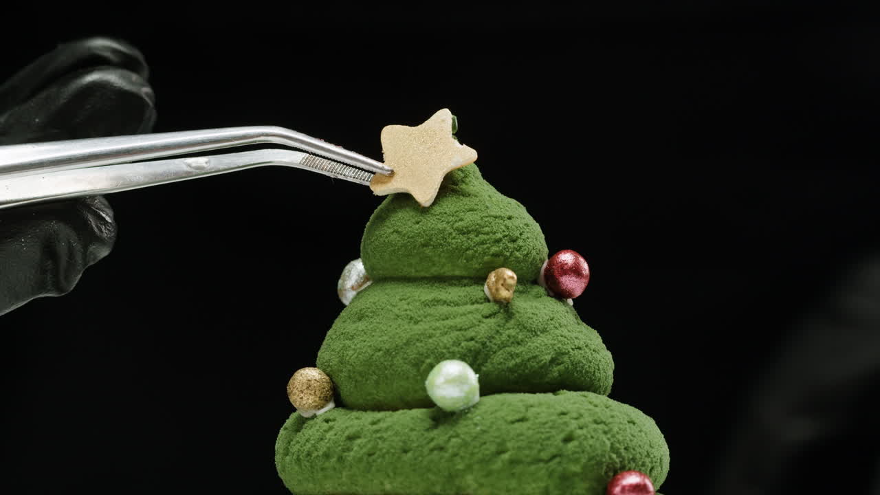Hand Decorating a Christmas Tree Dessert