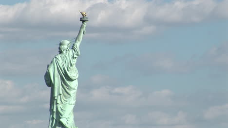 the statue of liberty against a cloudy sky