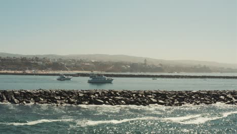 Beautiful-aerial-drone-of-California-coastal-beach-with-boats-in-the-harbor---Graded