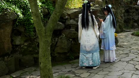 chinese women in hanfu clothing taking selfies with mobile phones