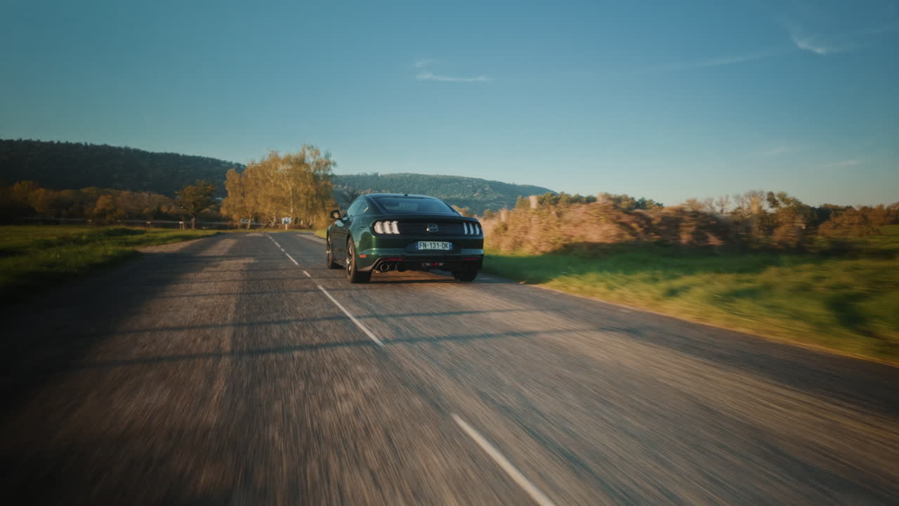Green Ford Mustang on a road