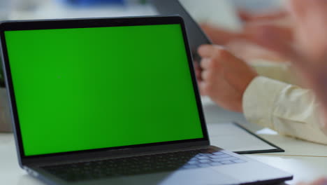 Unknown-man-hands-using-mockup-laptop.-Business-people-working-meeting-room