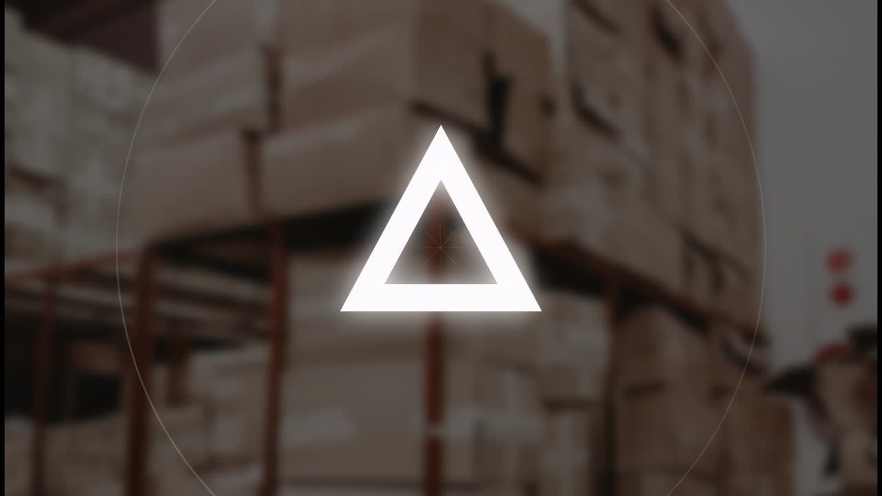 Warehouse with stacked boxes, triangle symbol animating over blurred background