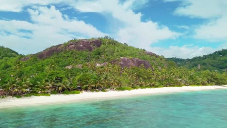 aerial view of tropical white sand beach and turquoise clear sea water and palm trees forest
