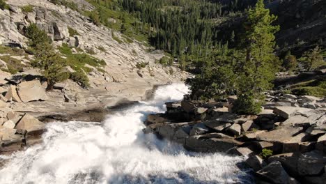 stabilized dji 4k drone footage slowing flying over the top of a massive waterfall in desolation wilderness located in the mountains of california and nevada