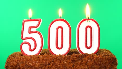 cake with the number 500 lighted candle. chroma key. green screen. isolated