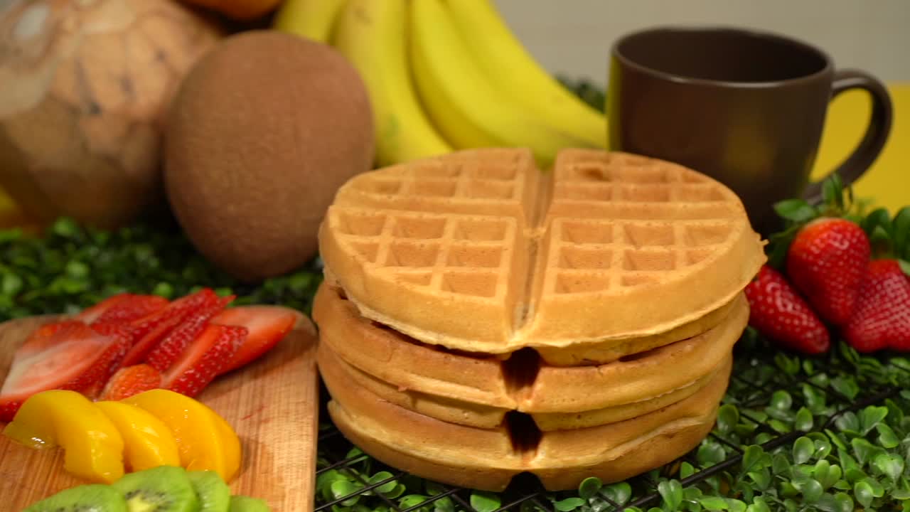 Garden fresh breakfast fruits and waffles slow motion