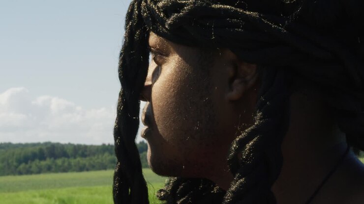 Samson looking around and turning to face surrounding green landscape, Biblical character with long dreads, Israelite warrior and judge, black male in old testament, Christian