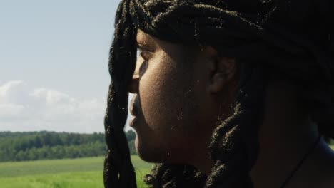 samson looking around and turning to face surrounding green landscape, biblical character with long dreads, israelite warrior and judge, black male in old testament, christian