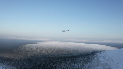 helicopter over snowy mountains