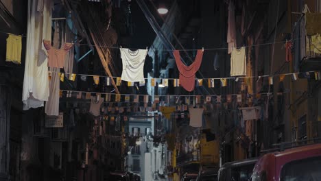 hanging clothes in a vibrant naples street at night, italy