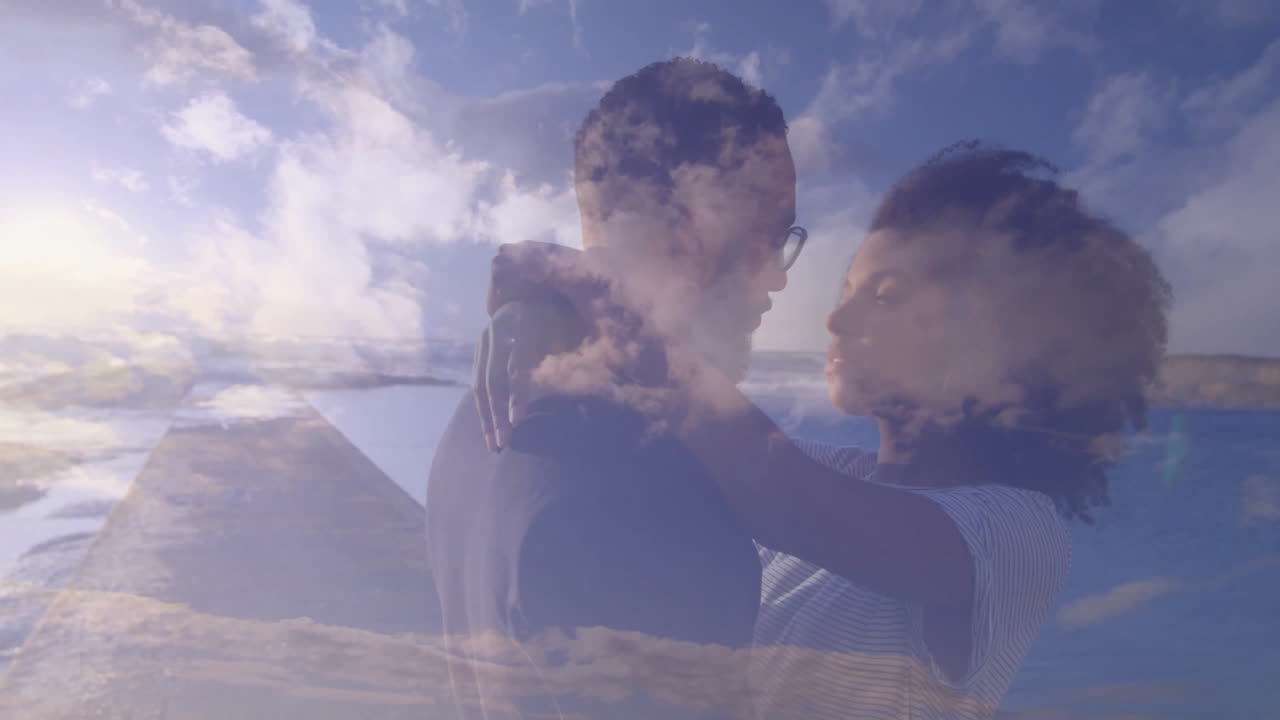 Embracing couple with animation of serene sky and clouds in background