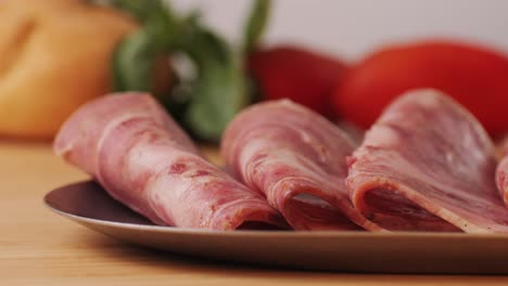 black bull sausage ham, tongue pork dry-cured sausage on a black background, traditional spanish delicatessen food, close up.