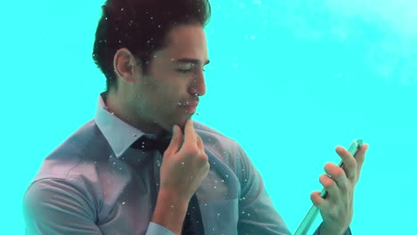 Thoughtful-man-using-smartphone-underwater-