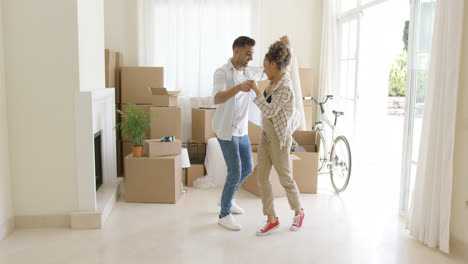 Happy-young-couple-celebrating-moving-home