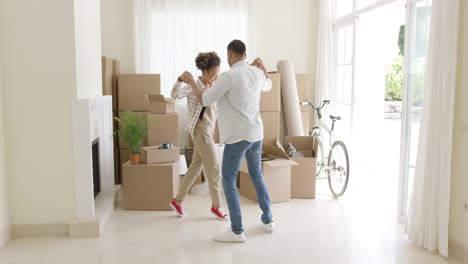 happy young couple celebrating moving home