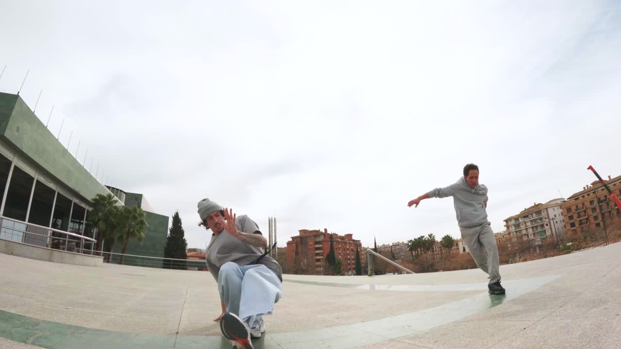 Breakdancers performing and handshaking in urban environment