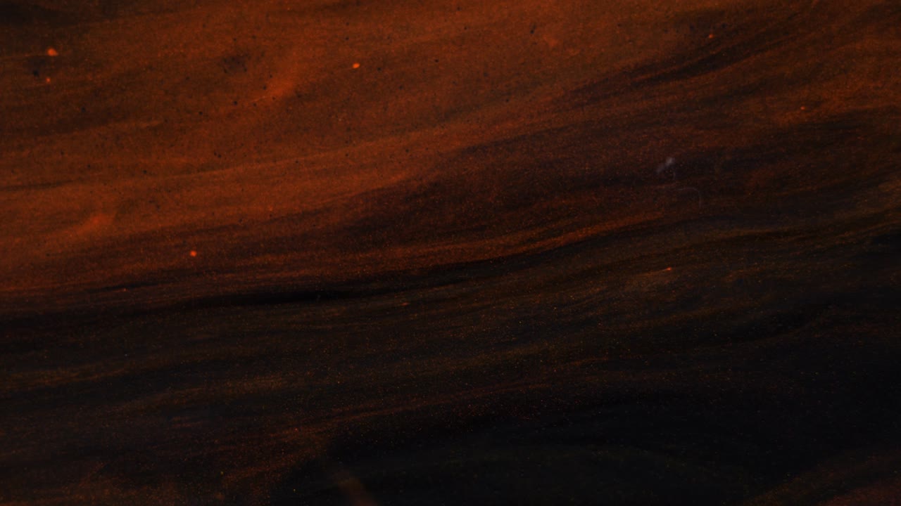 flujo de colores rojos y dorados en un fondo negro tridimensional en movimiento, transición.