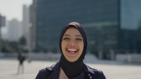 portrait happy young muslim woman laughing enjoying independent urban lifestyle in city successful female wearing hijab headscarf slow motion