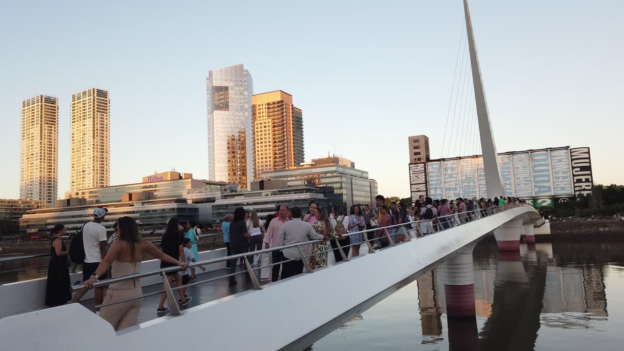 Tourists take selfies photos in Puerto Madero business center of Buenos Aires city, vibrant sunset